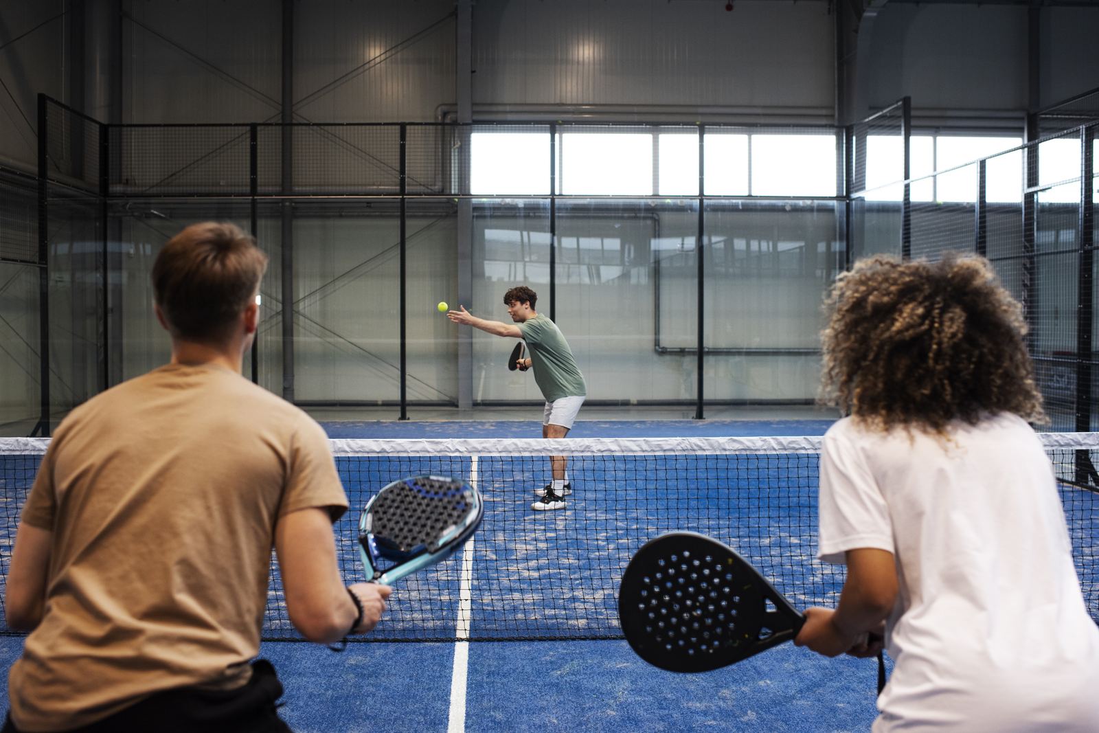Players on indoor padel courts at a club